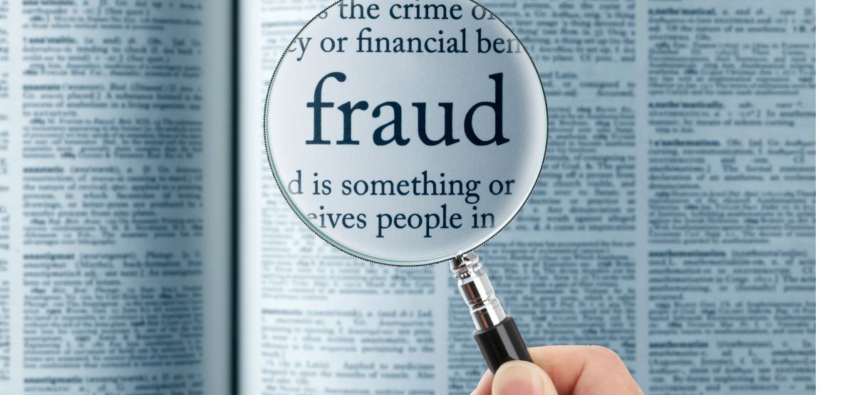 Magnifying glass on the word "fraud"
