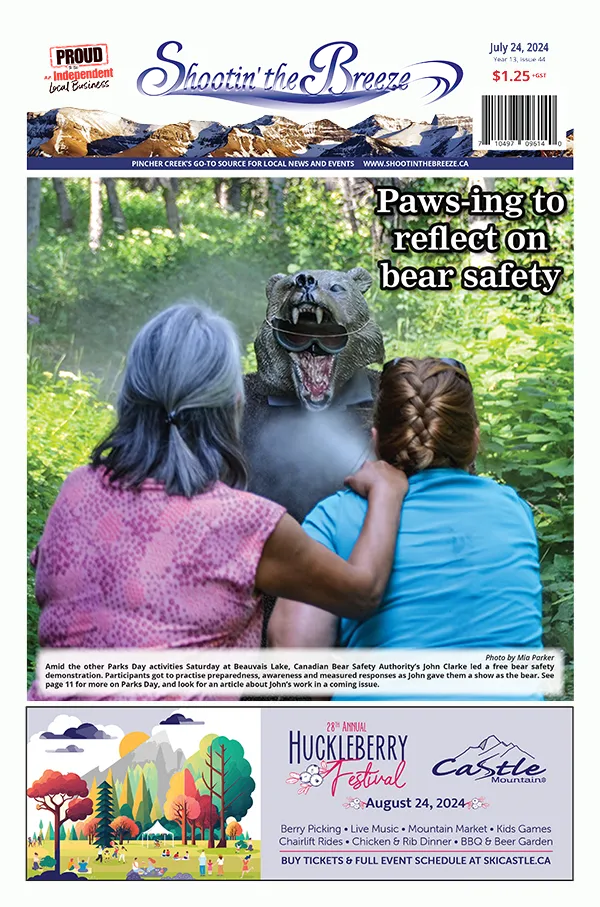 Front page of July 24, 2024, issue of Shootin' the Breeze. Amid the other Parks Day activities Saturday at Beauvais Lake, Canadian Bear Safety Authority’s John Clarke led a free bear safety demonstration. Participants got to practise preparedness, awareness and measured responses as John gave them a show as the bear.